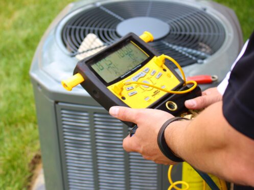 An AC tech repairing an AC in Hudson, OH