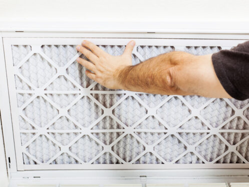 A man replacing a HEPA filter